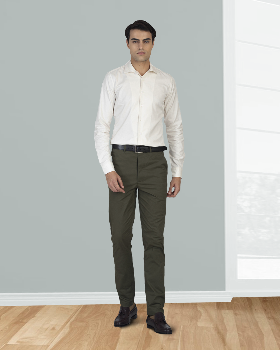 Model wearing custom Genoa Chino pants for men by Luxire in olive green hands at side