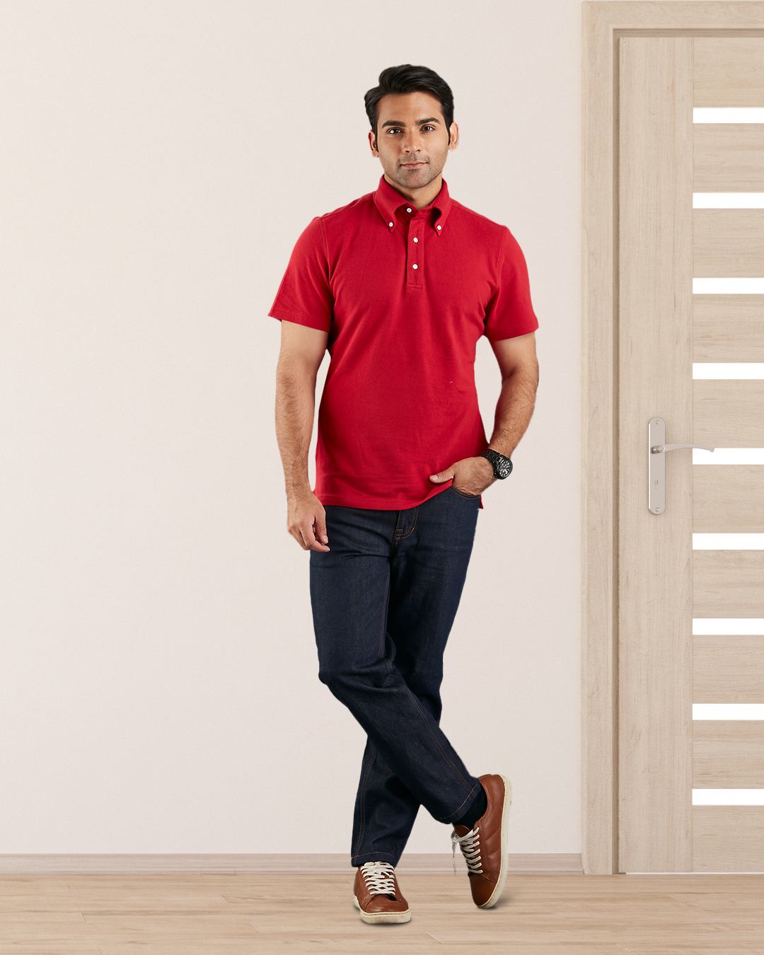 Model wearing the custom oxford polo shirt for men by Luxire in red one hand in pocket