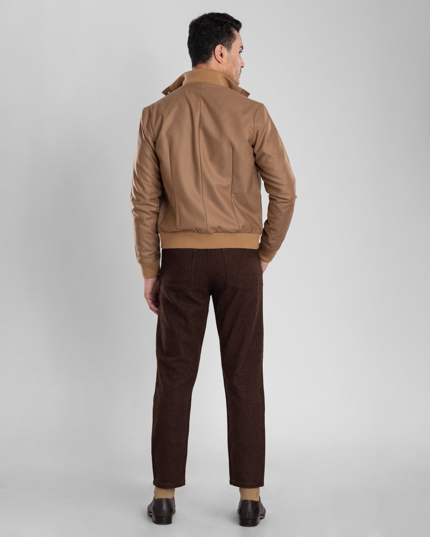 Back of model wearing the flannel shirt jacket for men by Luxire in sand with rib collar