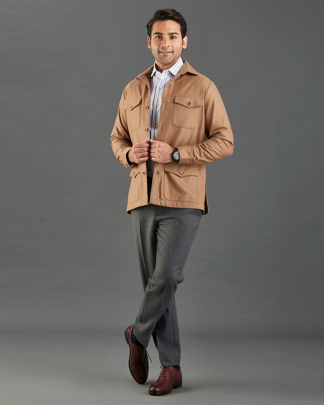 Front of model wearing the woolen flannel shirt jacket for men by Luxire in tan hands together