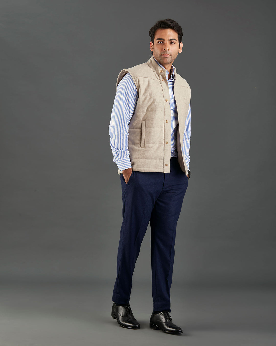 Front of model wearing the flannel quilted vest for men by Luxire in ecru hands in pockets hands in pockets