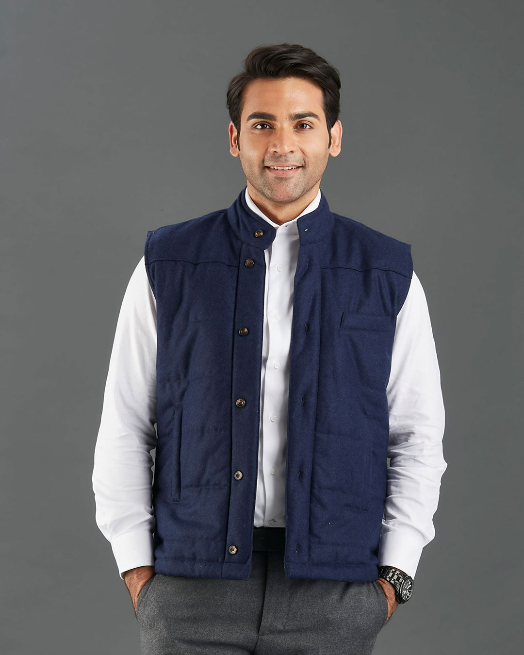Model wearing the flannel quilted vest for men by Luxire in navy hands in pockets 3
