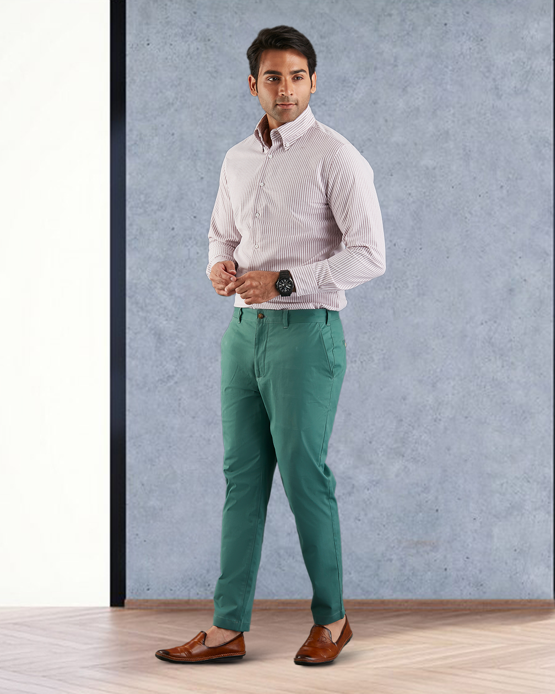 Model wearing custom Genoa Chino pants for men by Luxire in fern green hands together