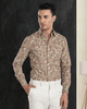 Front view of model  wearing custom wool Chino pants for men by Luxire in cream hand in pocket