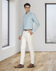 Model wearing custom Genoa Chino pants for men by Luxire in ivory cream hand in pocket