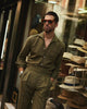 Male model wearing custom linen Gurkha pants for men by Luxire in olive wearing sunglasses