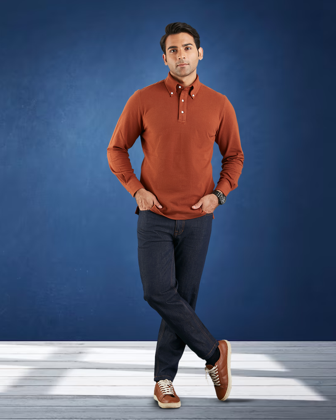 Model wearing the custom oxford polo shirt for men by Luxire in copper hands in pockets