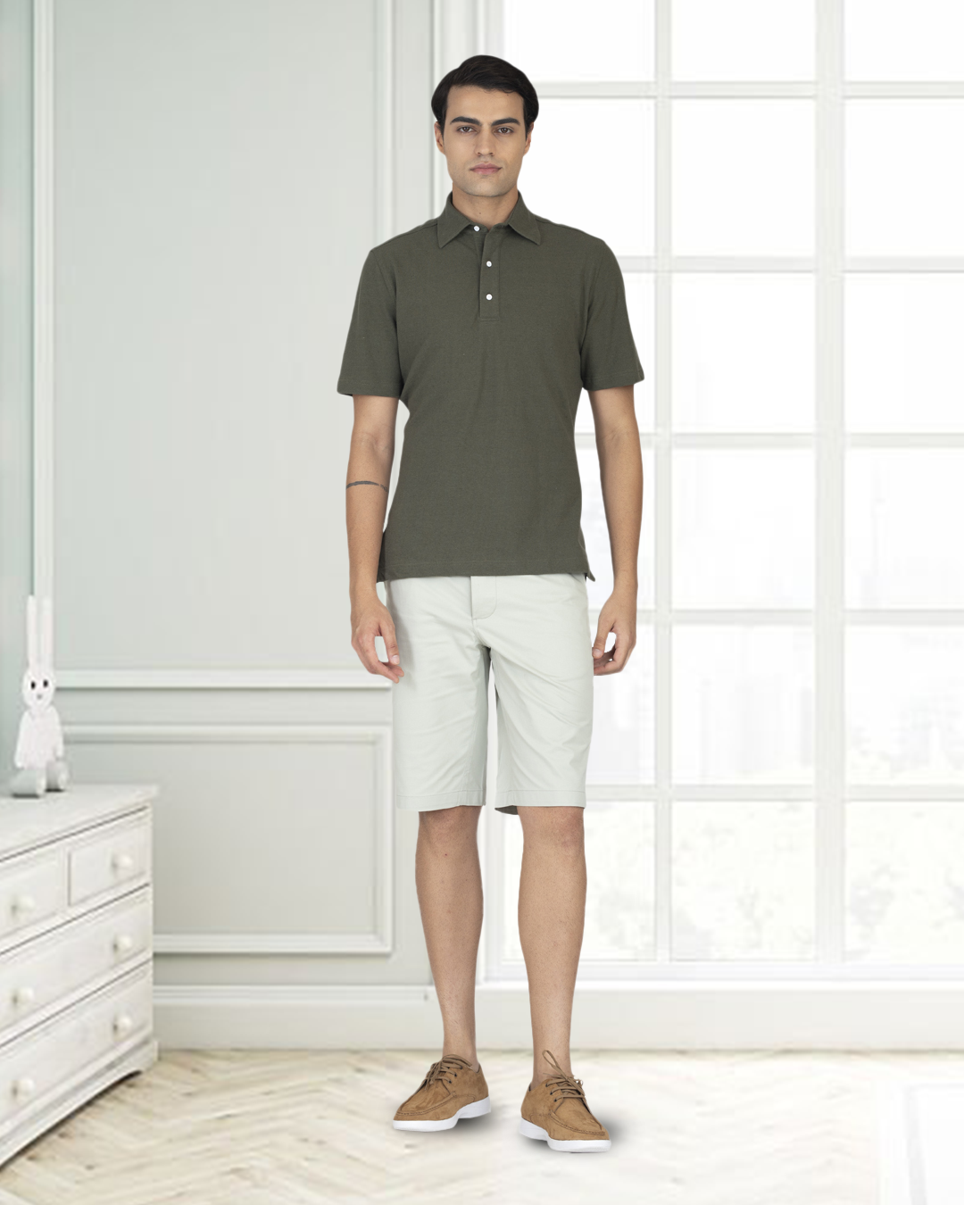 Front of model wearing the custom oxford polo shirt for men by Luxire in olive green hands at side