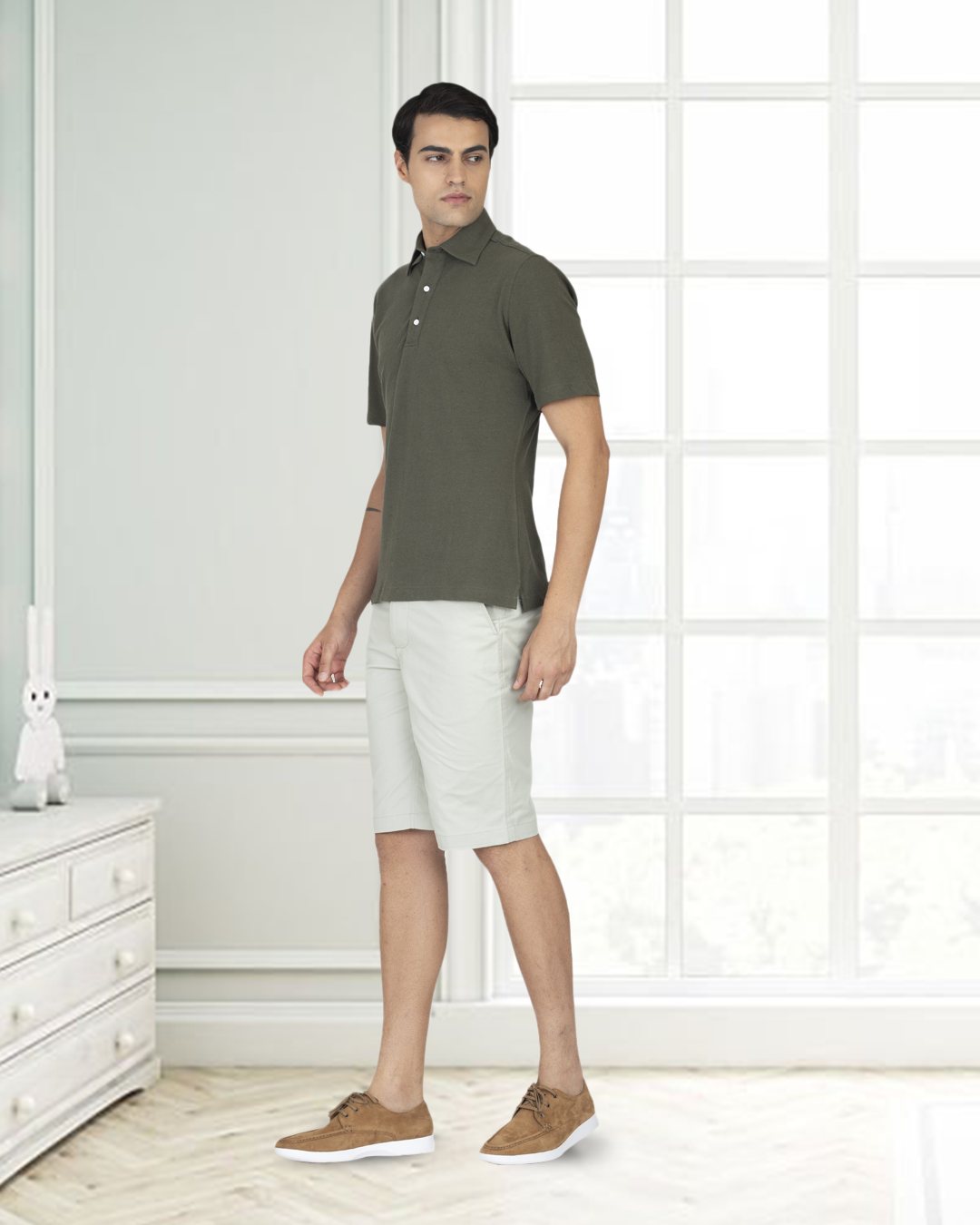 Front of model wearing the custom oxford polo shirt for men by Luxire in olive green hands at side 2