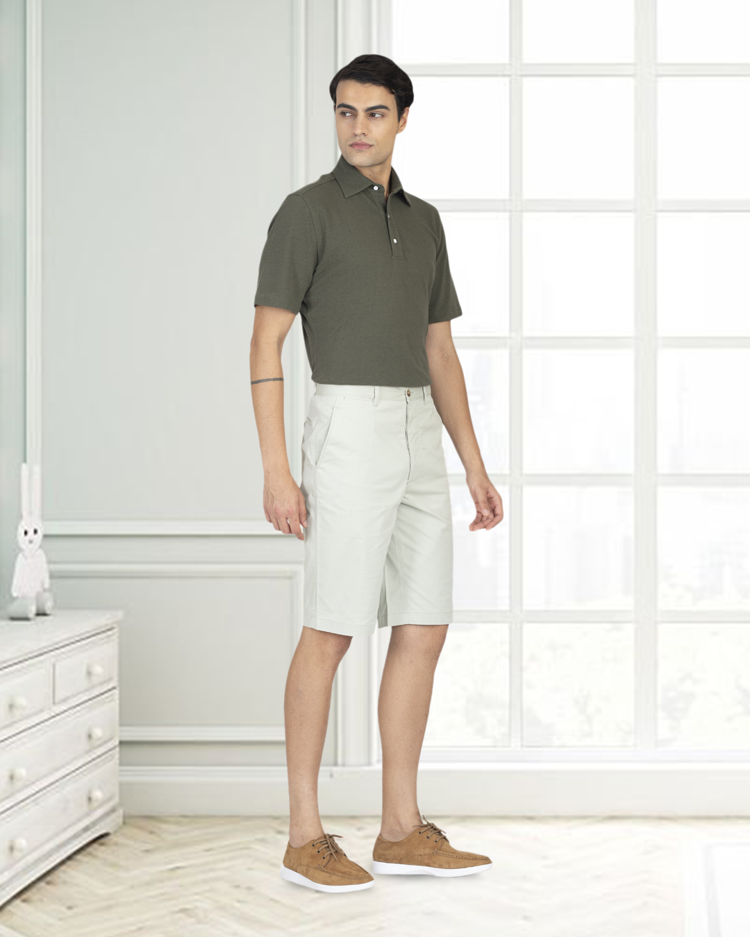 Front of model wearing the custom oxford polo shirt for men by Luxire in olive green hands at side 4