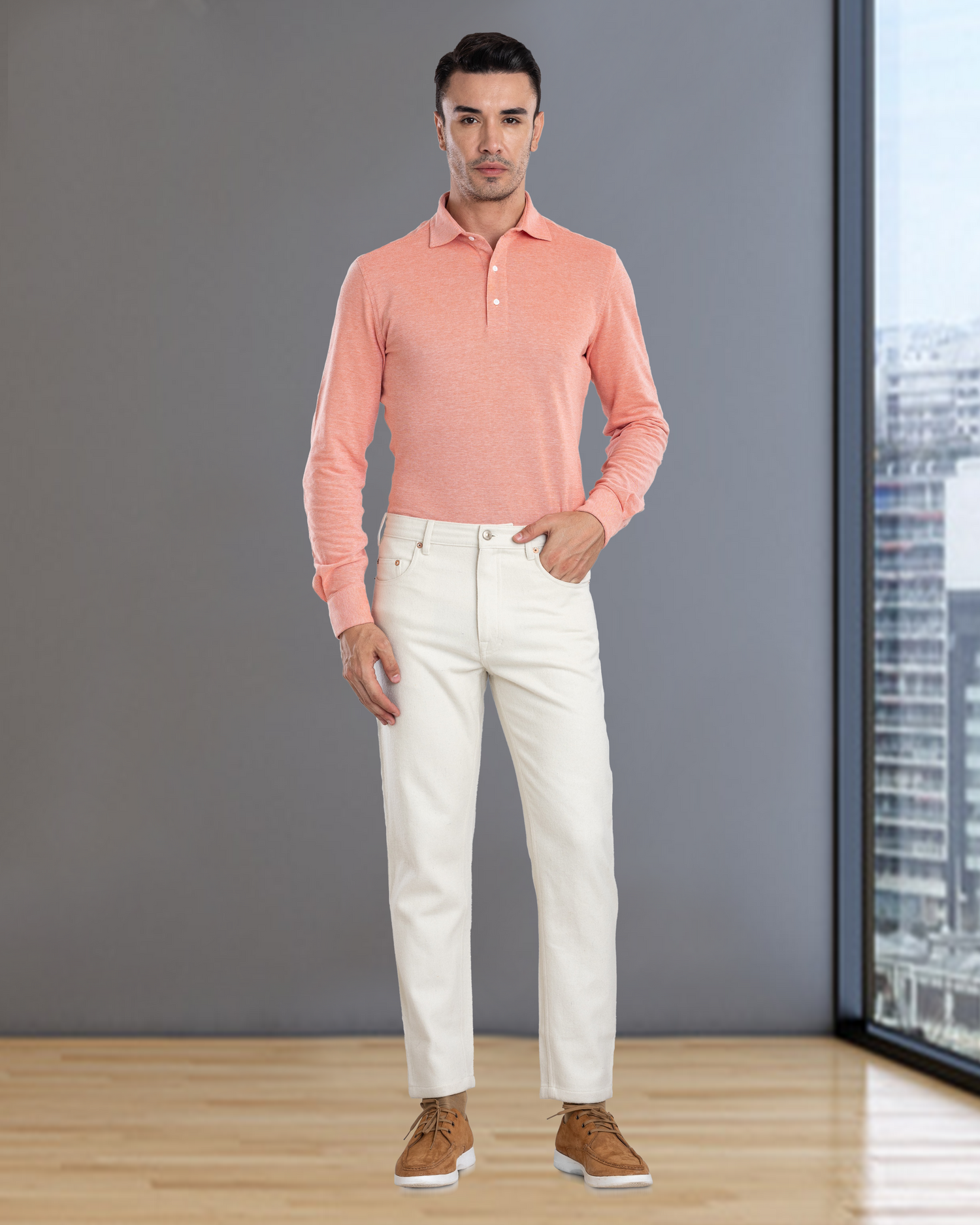 Front of model wearing the custom oxford polo shirt for men by Luxire in orange white hand on hip