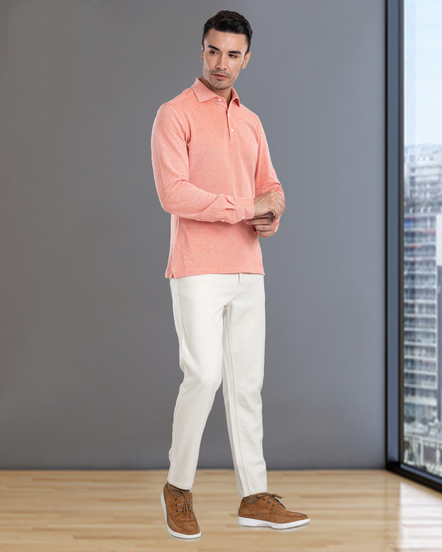 Front of model wearing the custom oxford polo shirt for men by Luxire in orange white hands together
