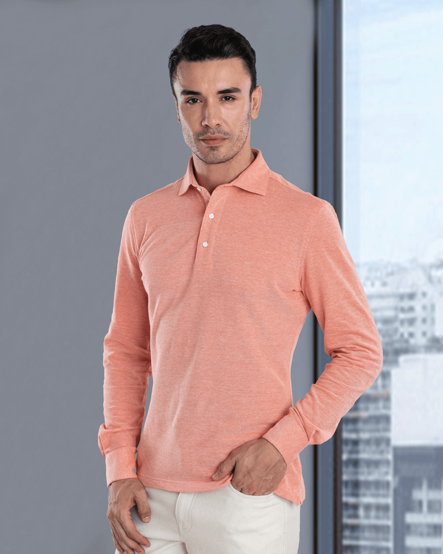 Model wearing the custom oxford polo shirt for men by Luxire in orange white