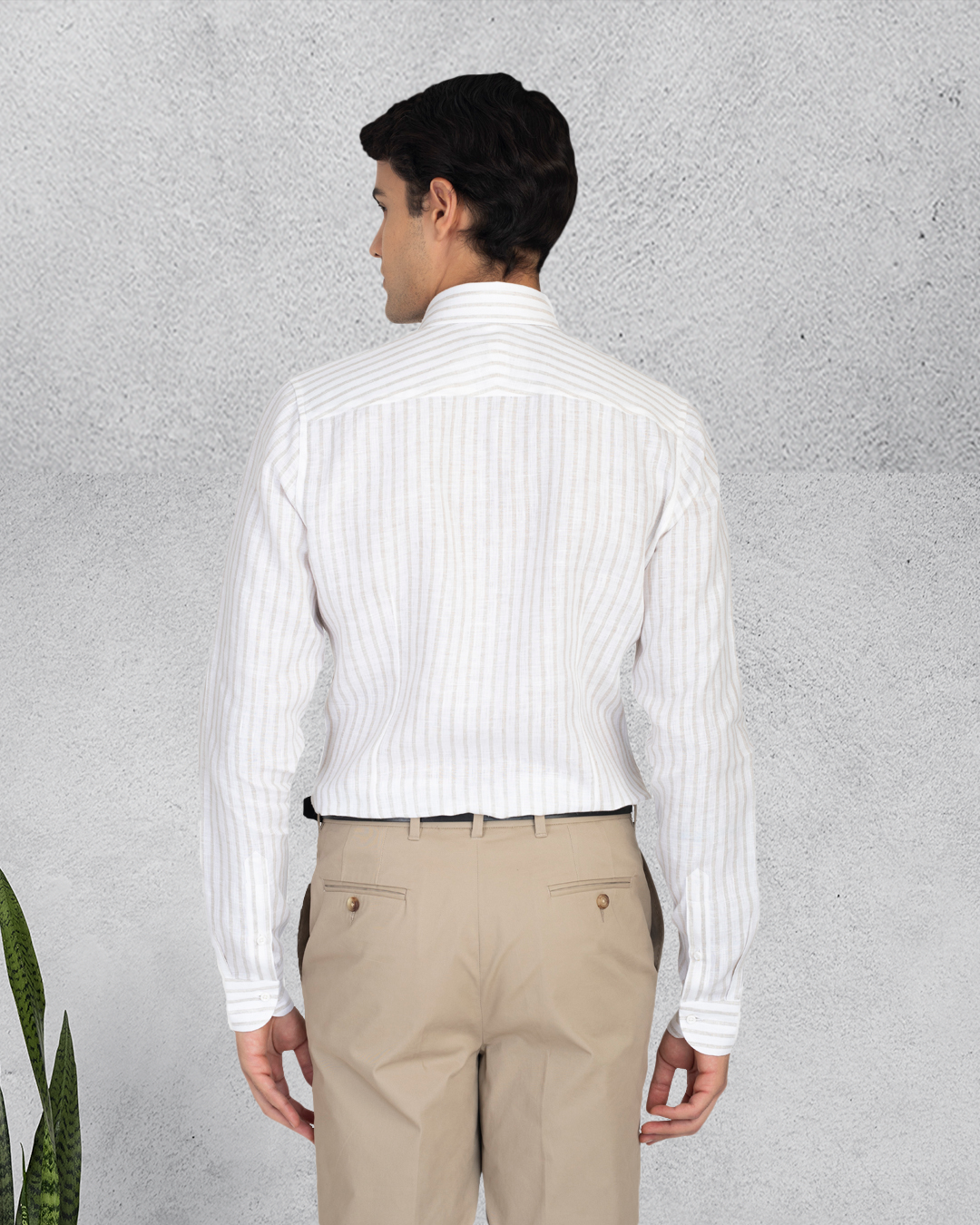 Back of model wearing the custom linen shirt for men in white with ecru stripes by Luxire Clothing 2