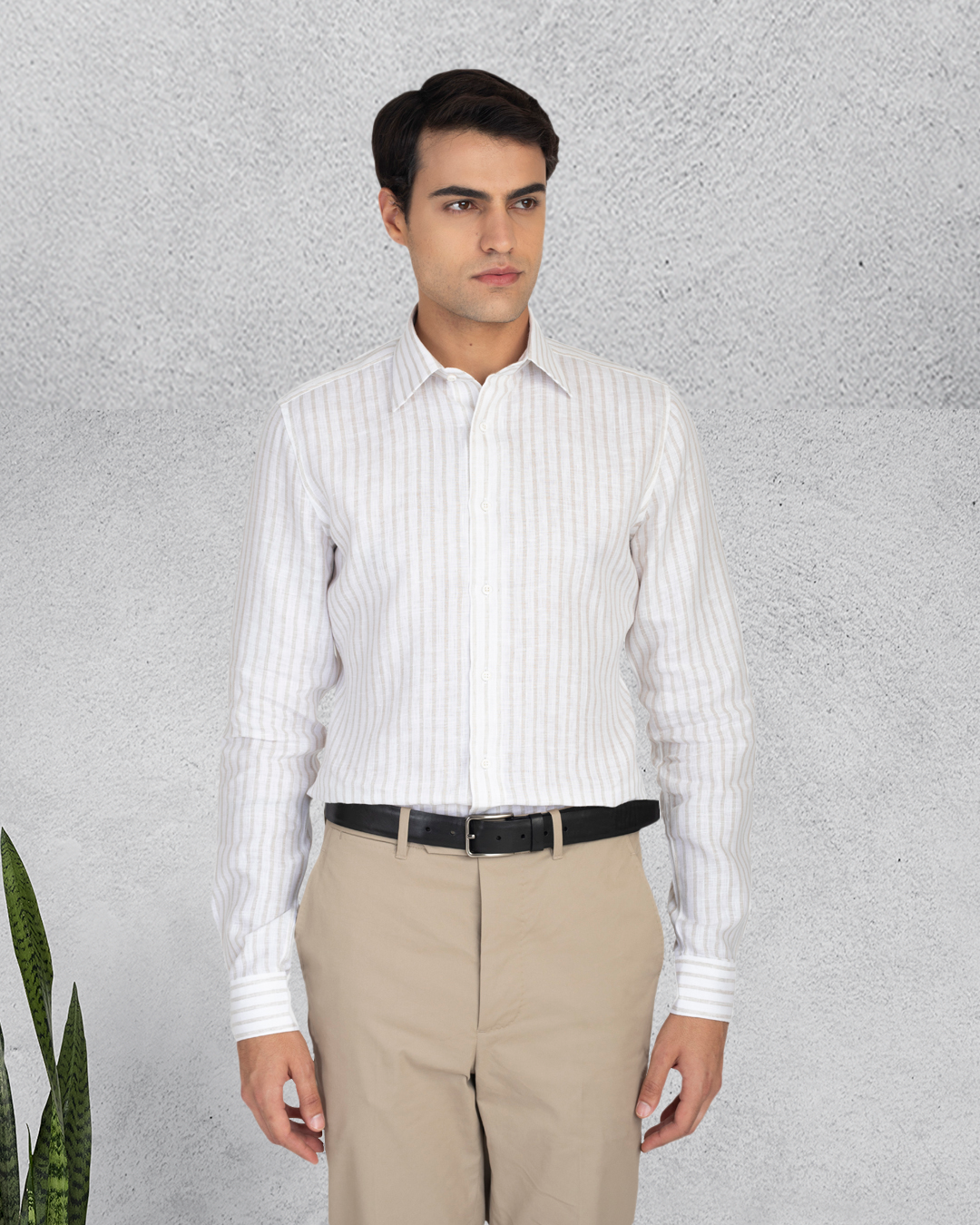 Model wearing the custom linen shirt for men in white with ecru stripes by Luxire Clothing