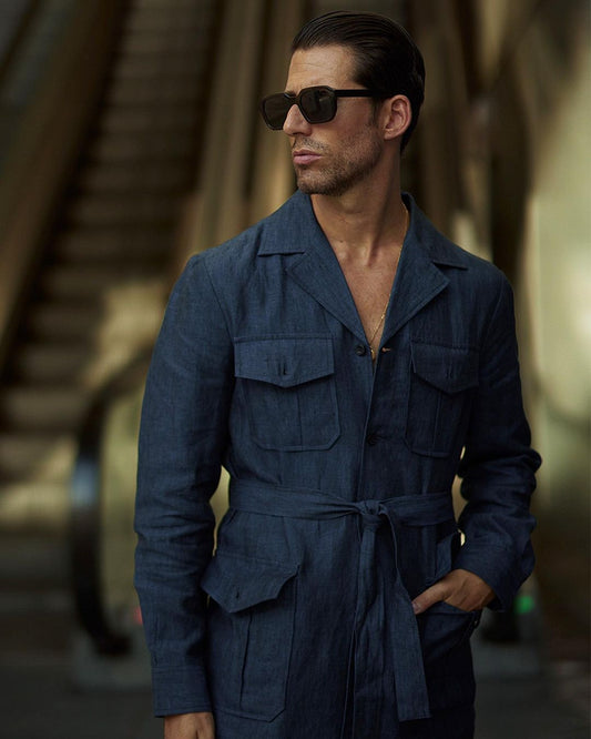 Model outside wearing the safari jacket in linen for men by Luxire in dark indigo